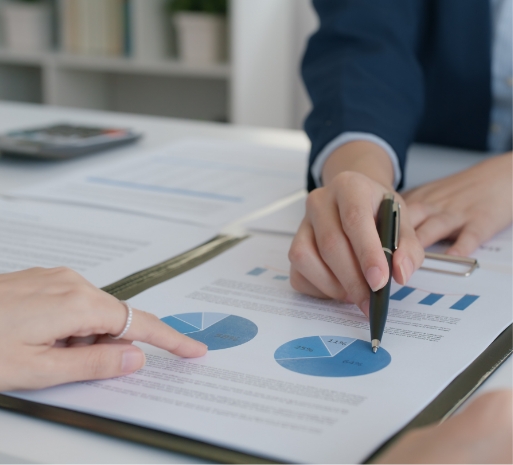 a picture of two hands pointing at charts to show that HRA shows results and we are powered by technology